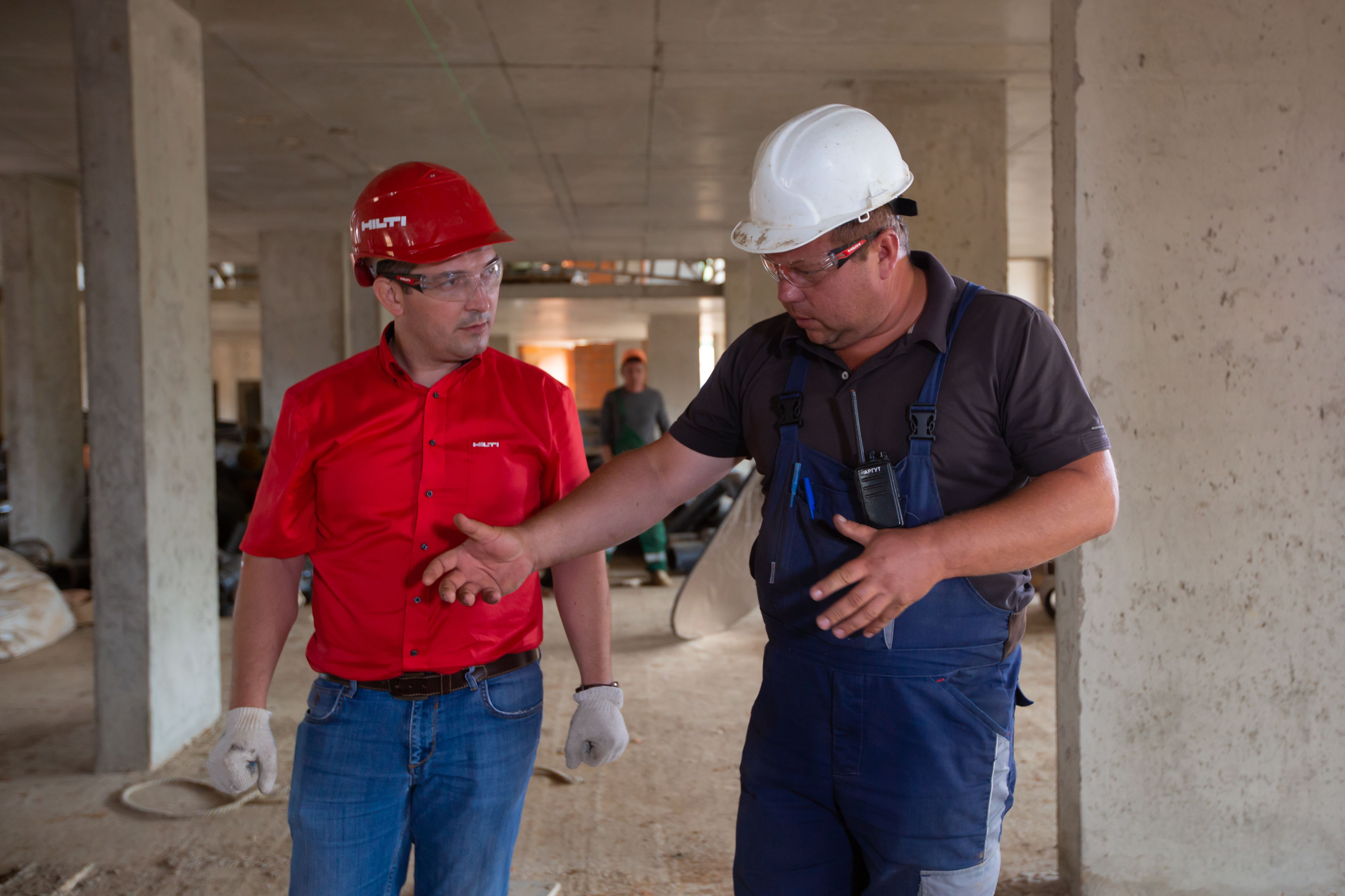 Construction workers discussing work on site